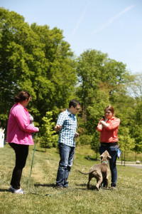 David works with Kelly and Chrislyn on the best way to set up a training exercise for a long-distance recall with Gunner. Hint: reward with tug toy.